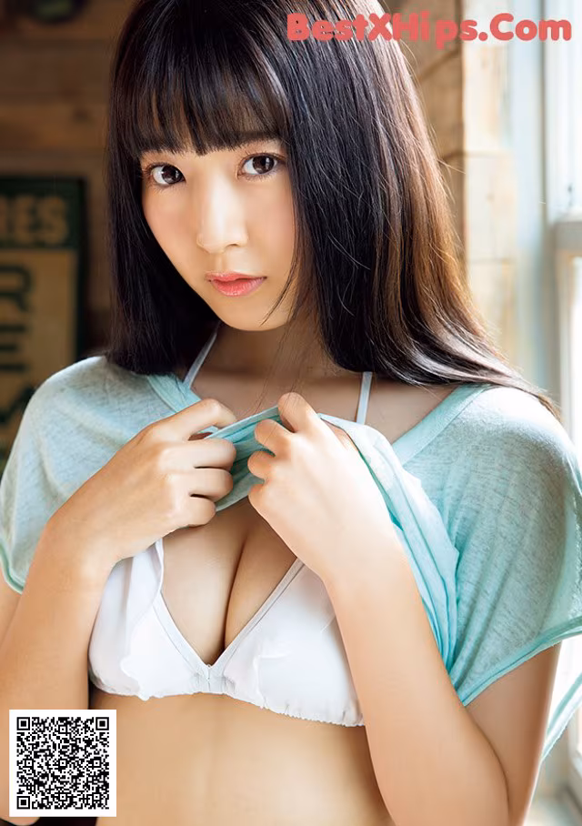 A woman in a white bra and a green shirt.
