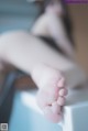 A close up of a person's bare feet on a table.