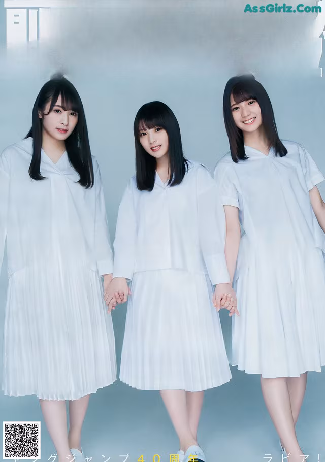 A group of three young women standing next to each other.