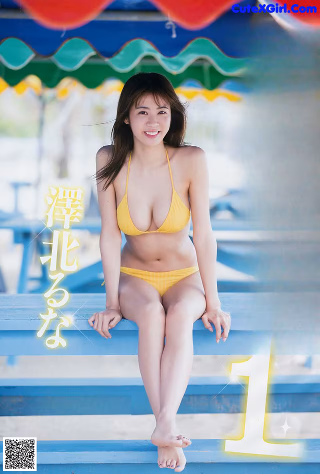 A woman in a yellow bikini sitting on a bench.
