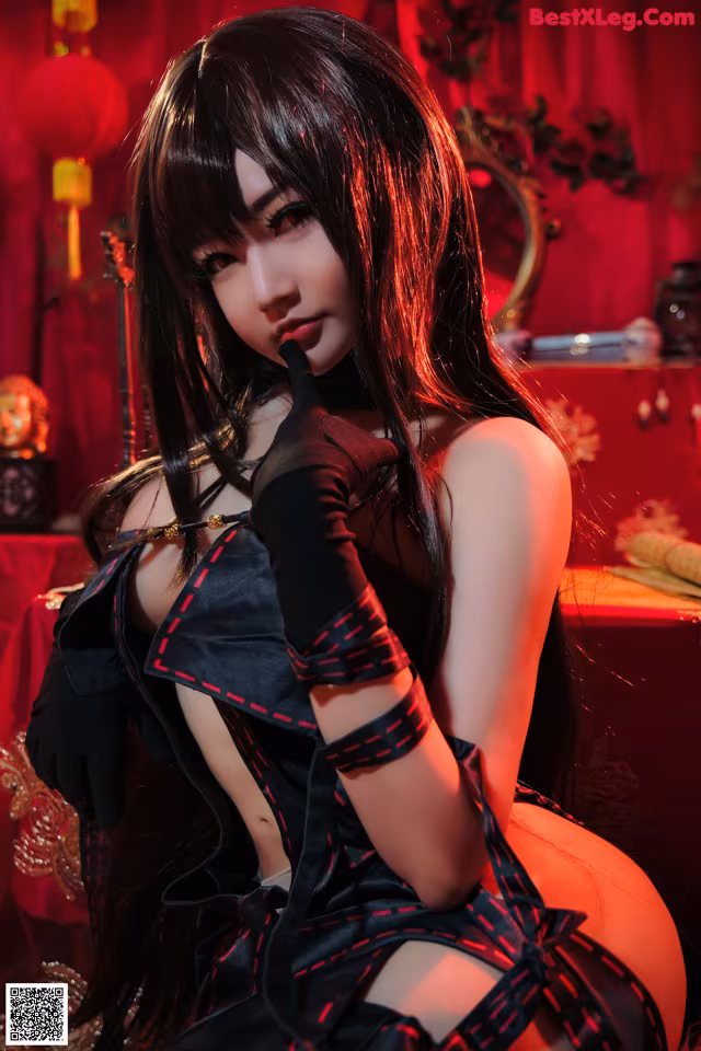 A woman in a black and red outfit posing for a picture.